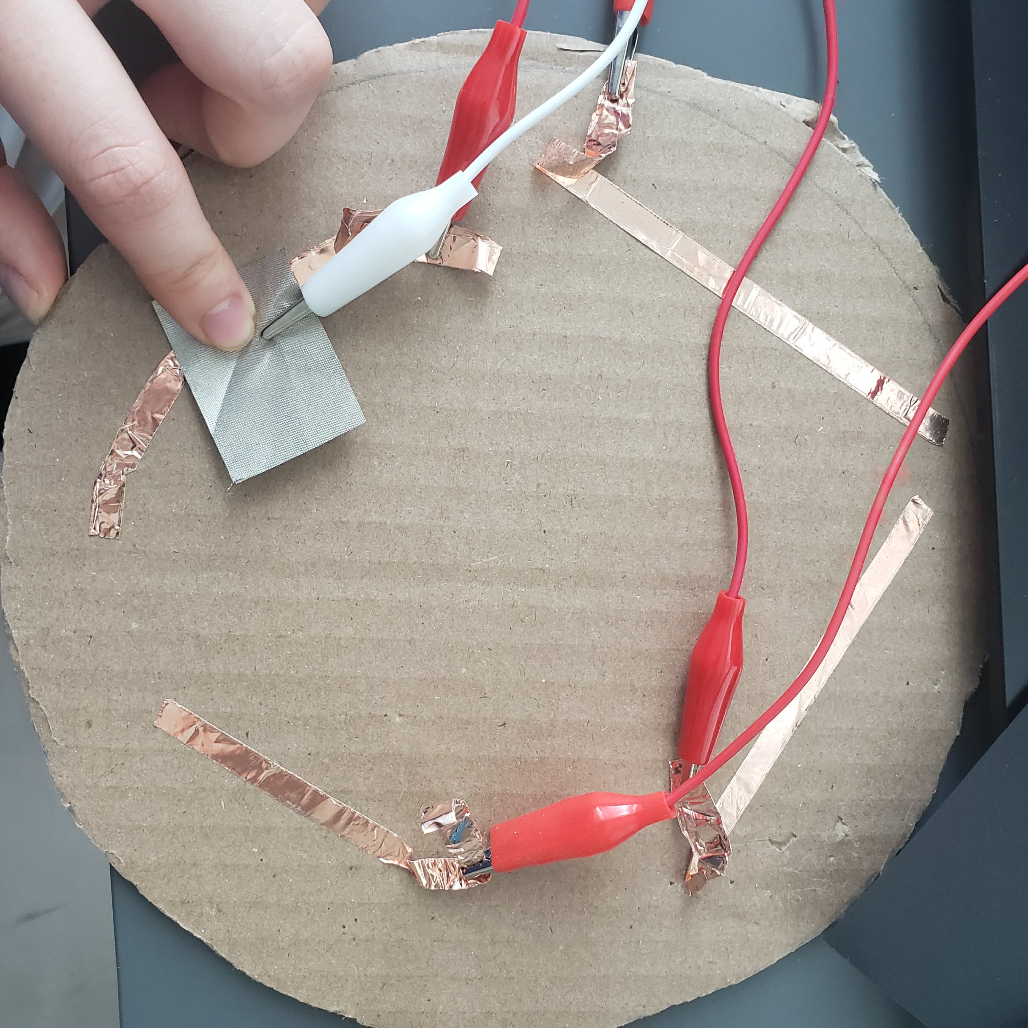 This is a basic prototype of the movement controls. The circuit is completed by having the conductive fabric touching the copper tape.