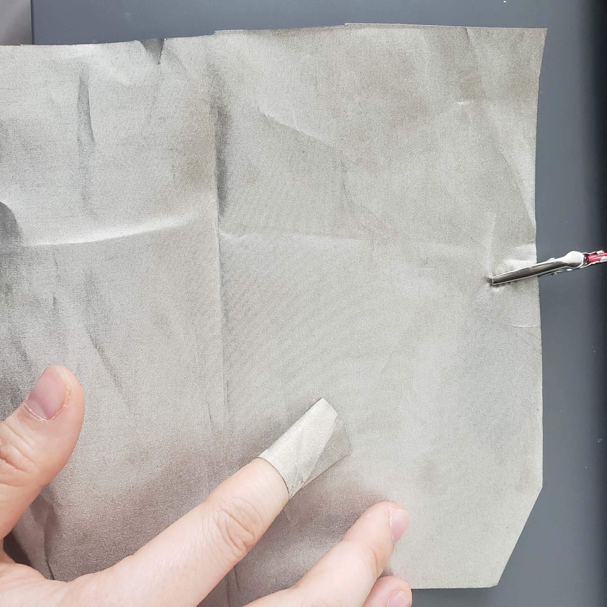 I connect the interaction by wrapping a piece of conductive cloth on my finger and touch another piece of conductive cloth