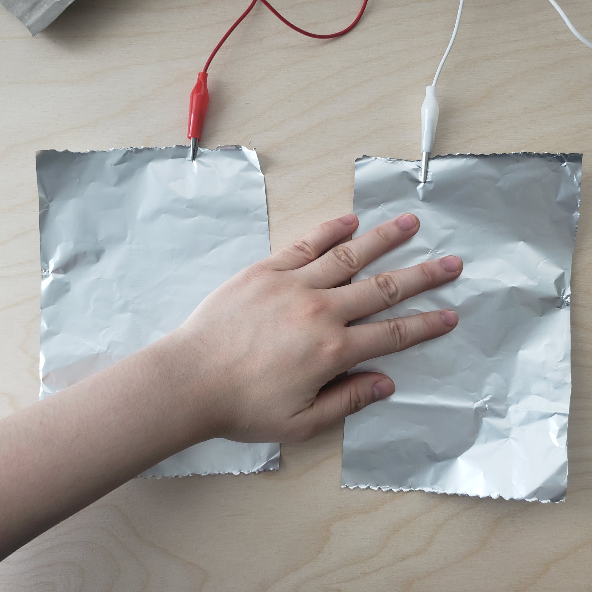 I connect the interaction by touching 2 pieces of alluminium foil at the same time. It was a surpise that it works.