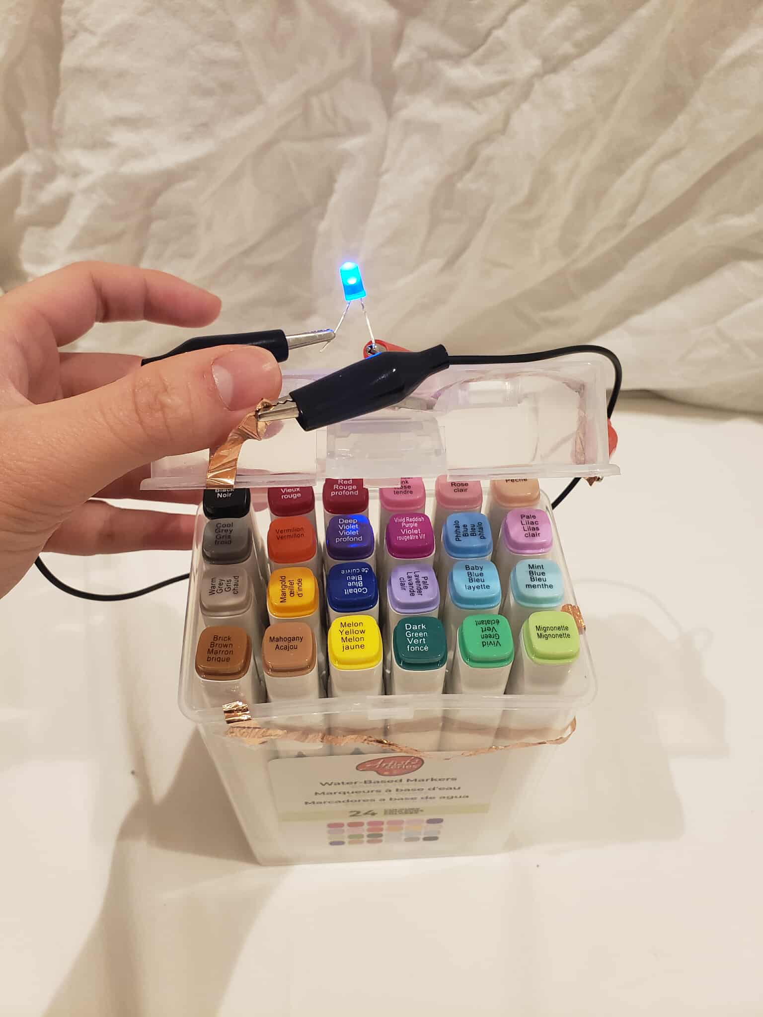 The pencil case with its circuit turned on when the case is opened. A part of the circuit is continuously short circuiting the circuit, preventing the light to be turned on. When the pencil case is opened, that part of the circuit is detached, and the circuit can work normally.