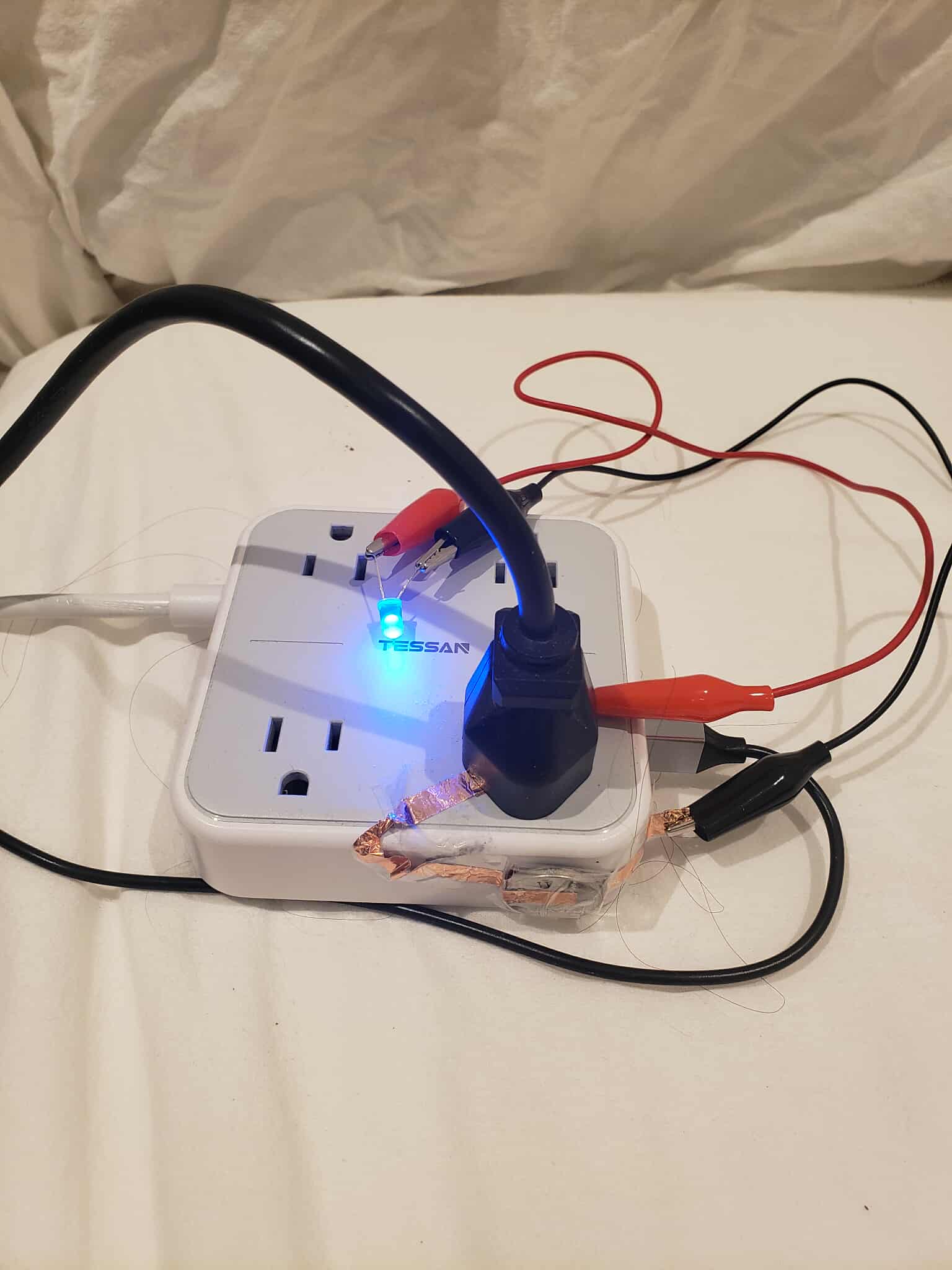 An extention cord with its circuit turned on. The switch is closed when a plug is put in.