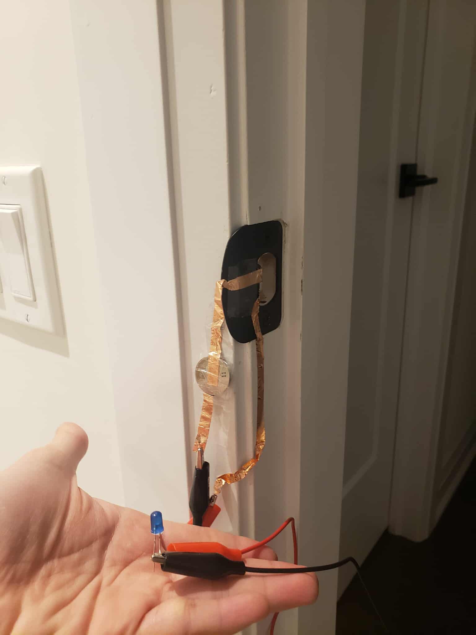 A turned off circuit using the conductive part of the other part of the door lock to complete the circuit