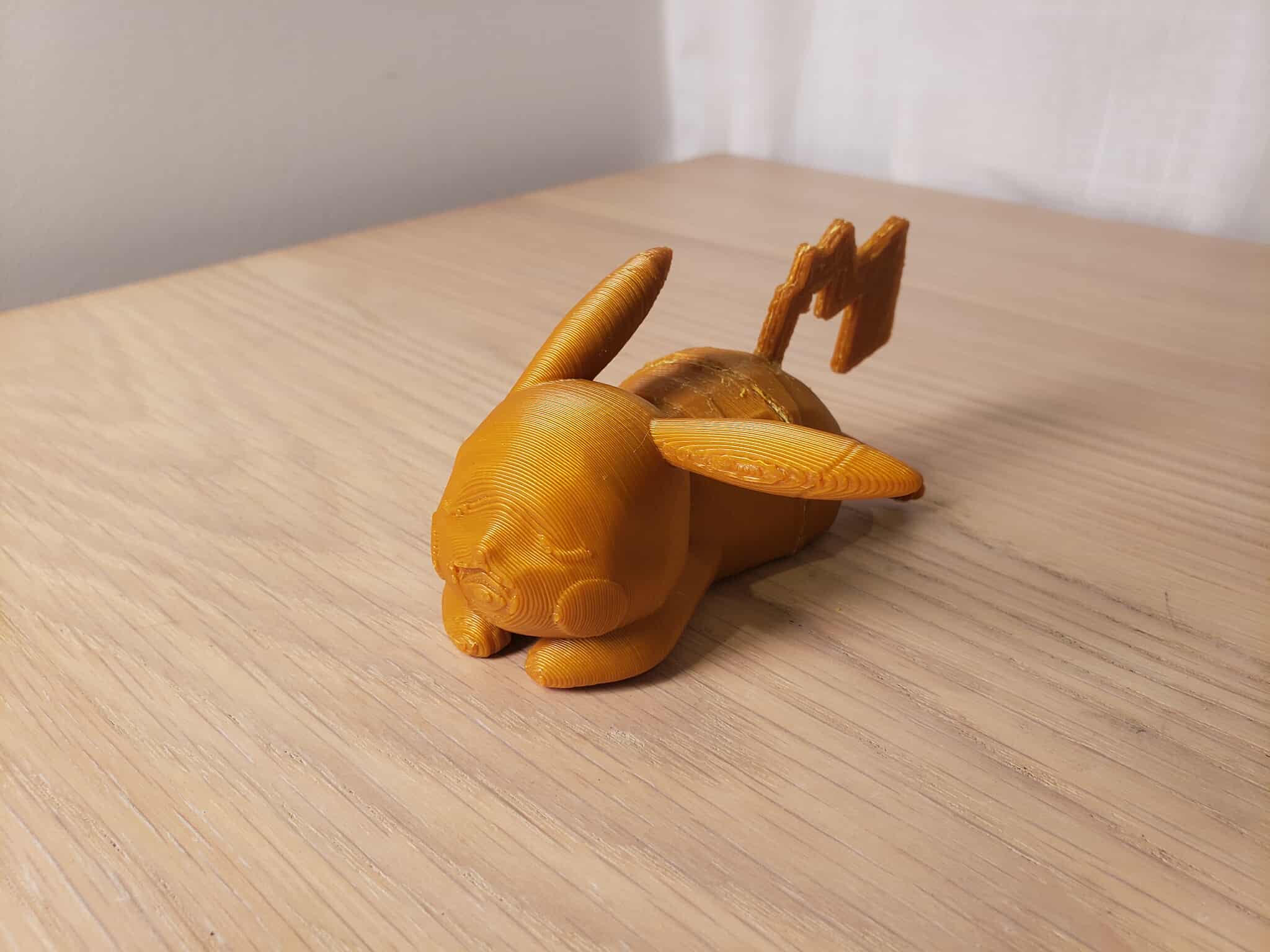 This is a model of a sleeping Pikachu. The rounded body, face, ears makes it looks cute, which contrast to the dynamic zigzag tail.