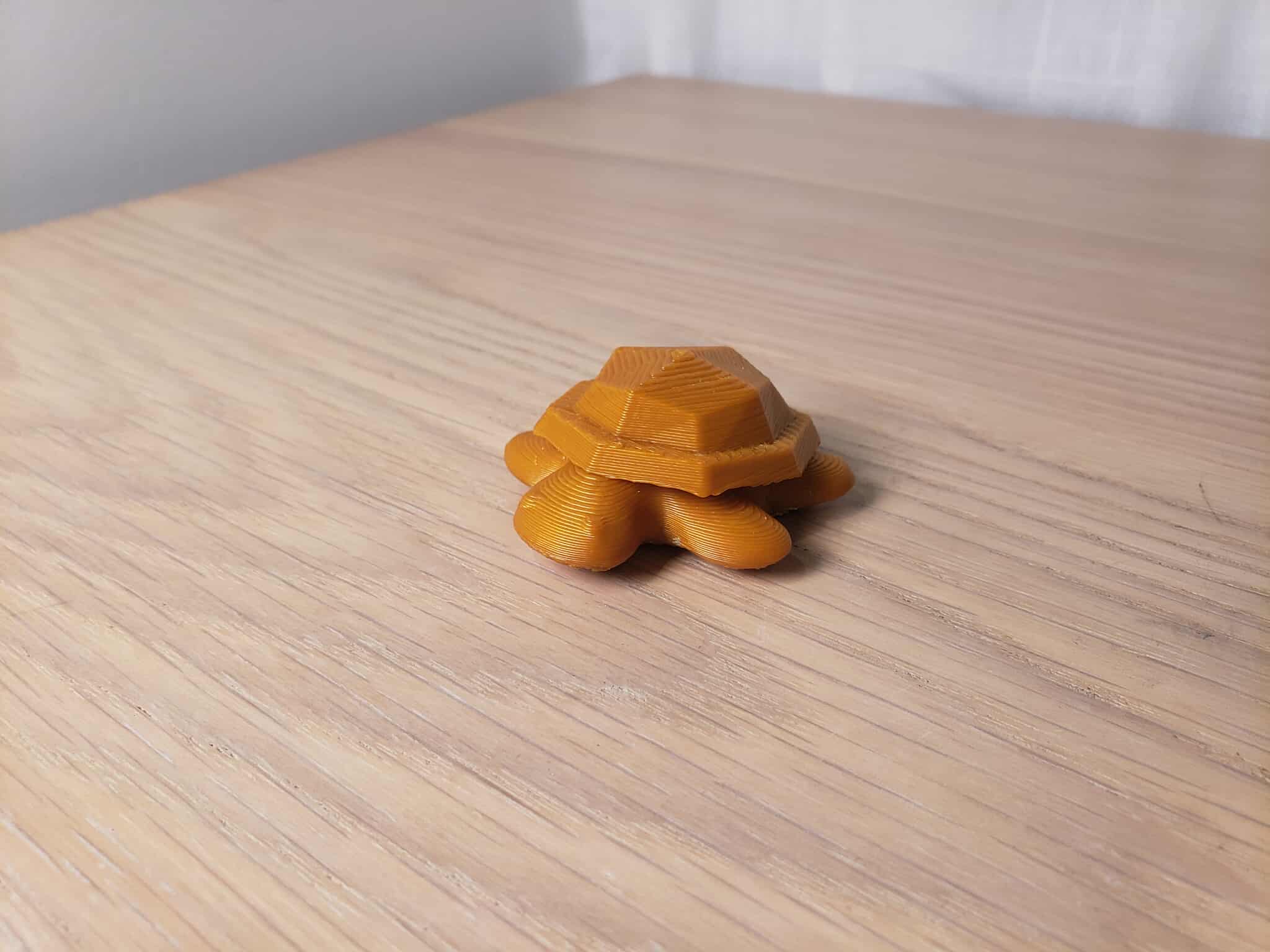 This is a model of a turtle doll. Its hard, geometric shell contrast with the soft, round, and cute limbs and body.